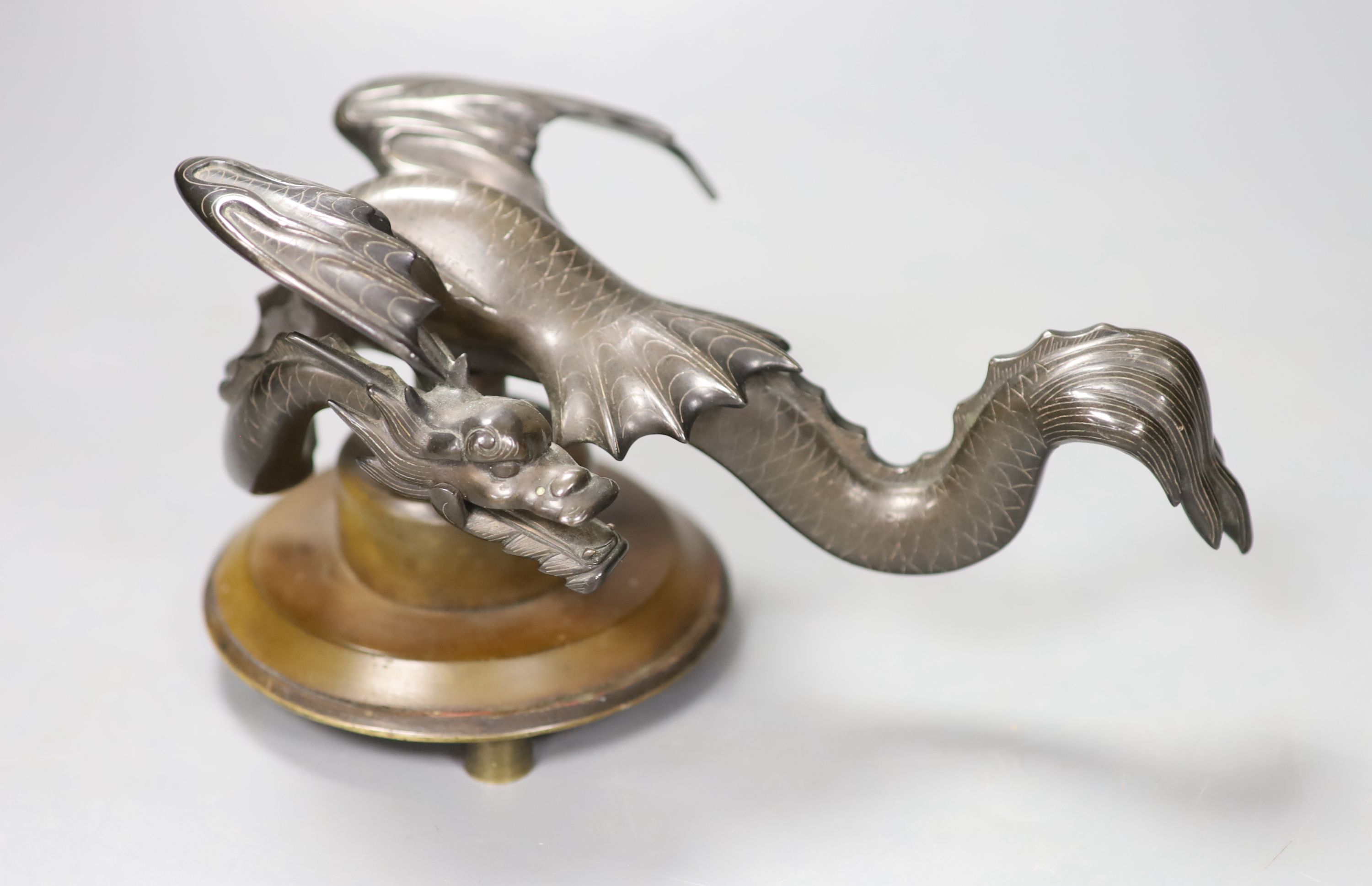 A Chinese bronze mounted dragon on stand, 18cm wide